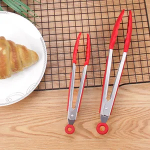Stainless steel food tongs with red silicone grip, ideal for kitchen baking and BBQ cooking.