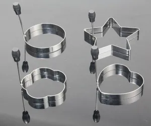 Stainless steel egg ring detail showing various geometric shapes for easy kitchen cooking.