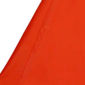 Silicone piping bag detail view, red flexible material texture with model text embossing.