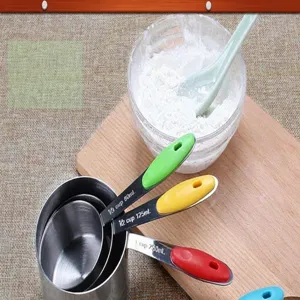 Stainless steel measuring spoons set with colorful silicone handles for baking and cooking.