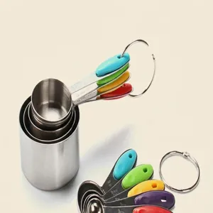 Stainless steel measuring spoons and cups set with colorful silicone handles and storage rings.