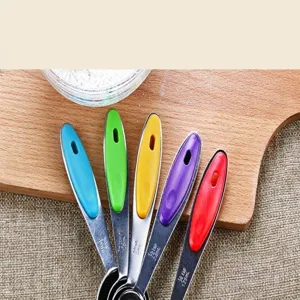 Stainless steel measuring spoons set with colorful silicone handles for baking.