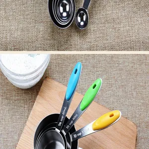 Detail view of stainless steel measuring spoons with colorful silicone handles for baking.