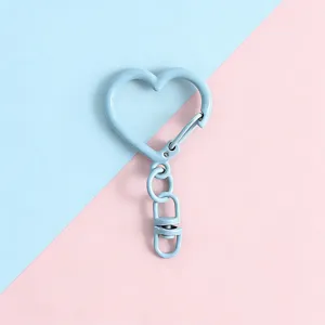 Close-up detail of light blue heart-shaped metal keyring clasp for DIY craft and bag accessories.