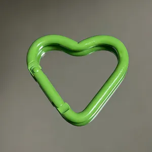 Close-up detail of green heart-shaped aluminum alloy carabiner snap hook, smooth finish.
