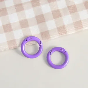Detailed view of purple zinc alloy spring rings, perfect for DIY keychains and handmade jewelry crafts.