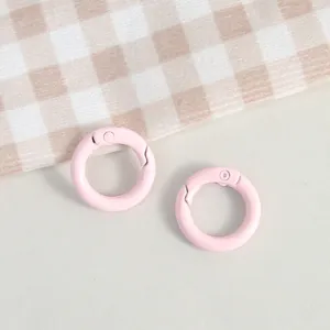 Close-up detail of pink metal spring ring clasp for DIY handmade jewelry accessories