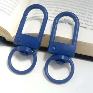 Detailed shot of blue metal U-shaped keychain gate clasp, swivel ring hardware for DIY craft.