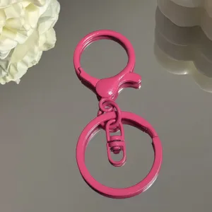 Nahaufnahme des rosa Metall-Schluesselanhaengers mit glatter Lackierung, Detailansicht.