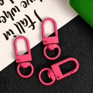 Detailed view of vibrant pink zinc alloy swivel lobster clasps for DIY crafts and keychains.