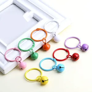 DIY colorful candy metal bells keyrings detail view, smooth baked paint hanging accessory charms.