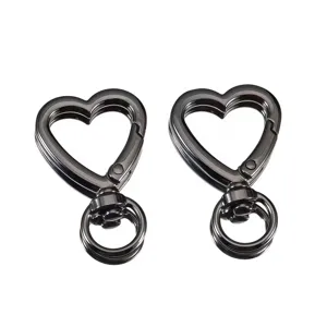 Close-up of gunmetal zinc alloy heart spring hooks, durable DIY bag hardware and keychain parts.