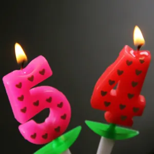 Numbered birthday candles set with heart patterns, perfect for party cakes and celebrations.