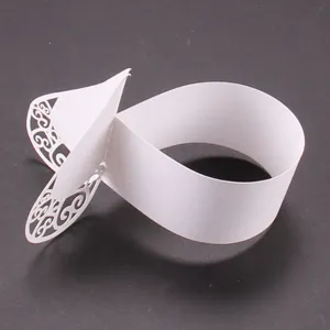 White paper laser cut decorative wrapper detail for chocolate gift box packaging.