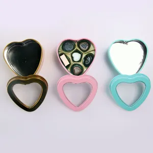 Heart shaped metal tin gift boxes set, empty and chocolate filled containers, decorative packaging.
