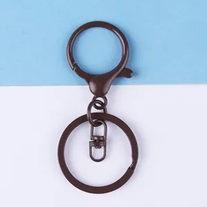 Brown metal lobster clasp keychain accessory detail, hardware connector ring for DIY crafts.