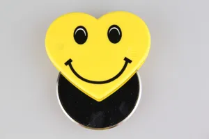 Stainless steel pizza cutter with cute yellow heart smiley face handle for baking tools.
