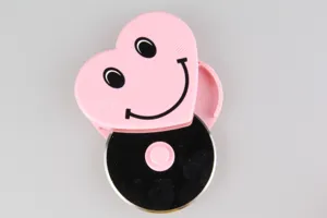Stainless steel pizza cutter wheel detail, pink heart smiley face shape, kitchen baking tool.