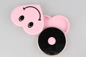 Detailed view of the pink heart-shaped stainless steel pizza cutter wheel with smiley face.