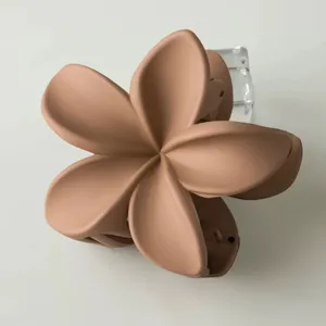 Matte plumeria flower hair claw clip, elegant nude hair accessory for daily styling.