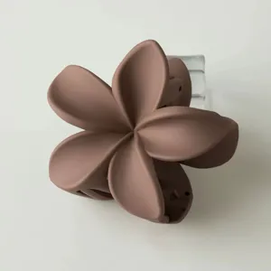 Matte mauve plumeria flower hair claw clip, elegant everyday styling accessory for women.