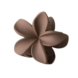 Brown matte plumeria flower hair claw clip detail view, stylish hair styling accessory for women.
