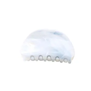 Detailed view of white marbled half-moon hair claw clip, sleek hair accessory for daily styling.