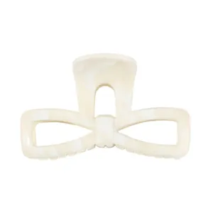Close-up detail of the elegant marble bow hair claw, featuring chic acrylic design for daily styling.
