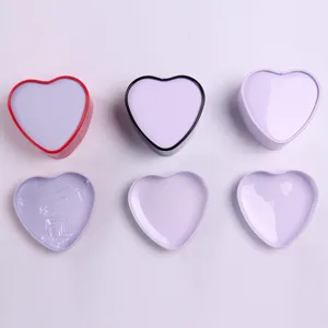 Close-up of heart-shaped metal gift boxes showing interior details and multi-colored rims.