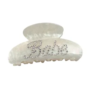 Elegant white glitter acrylic hair claw clip with rhinestone babe letters for women hair styling.
