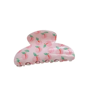 Cute peach print hair claw clip detail, pink translucent acrylic shark clip for women.