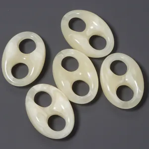 Acrylic double-hole pig nose beads detail shot showing marbled white and beige DIY jewelry accessory.
