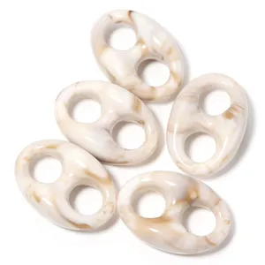 Acrylic pig nose bead detail view, tortoiseshell swirl pattern, DIY handmade bracelet accessory.