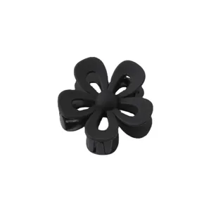Black matte hollow flower hair claw clip for women, stylish acrylic shark clip for styling.