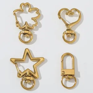 Moschettoni girevoli in metallo dorato a forma di cuore, stella e fiore per borse e gioielli.