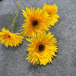 Artificial yellow gerbera flower head detail, realistic wedding floral decor arrangement.