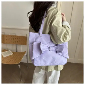 Vista di dettaglio della borsa shopper in tela viola Y2K con grande fiocco e stelle.