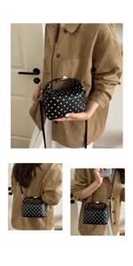 Black white polka dot handbag detail showing premium texture, elegant style and portable design.