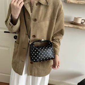 Stylish black polka dot shoulder bag, versatile cosmetic handbag for women daily use.