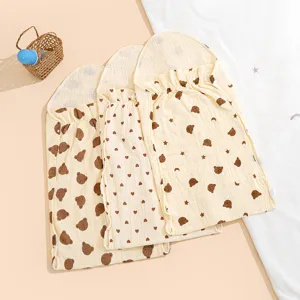 Breathable cotton gauze baby sleeping bag with cute bear and heart prints for summer.
