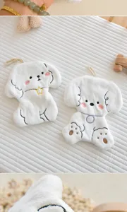 Close-up detail of cute cartoon animal hanging hand towel, soft coral fleece absorbent.