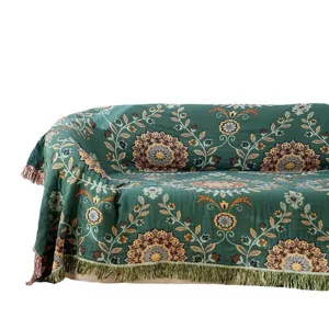 Green woven cotton sofa blanket with vintage floral mandala patterns and fringe design.