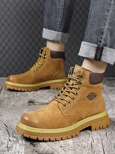 Detail view of men's yellow work boots featuring durable nubuck leather and rugged sole.