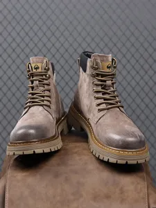 Men's suede work boots detail, featuring thick non-slip rubber soles and retro design.