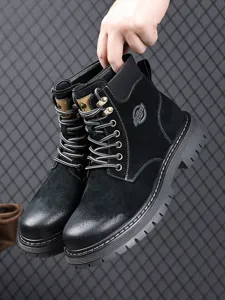 Black leather work boots detail view, stylish men mid-top martin boots with thick rubber sole.