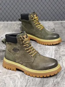 Detailed view of men's retro work boots, featuring suede upper, thick rubber sole and lace-up.