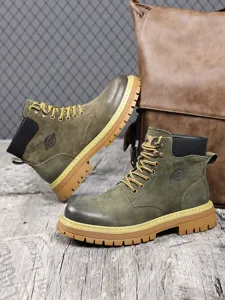 Detailed shot of green martin boots with thick sole and lace-up design for men winter wear.