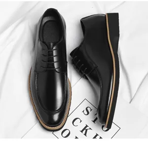 Detailed shot of black leather dress shoes featuring pointed toe and classic lace-up design.
