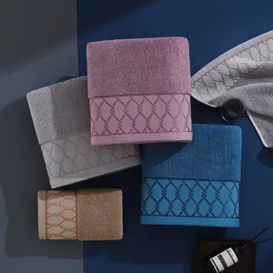 Cotton towel set detail view showing soft texture and delicate woven border in assorted colors.
