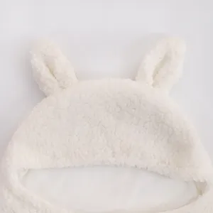 White fluffy baby sleeping bag hood detail, soft plush newborn swaddle blanket with cute ears.
